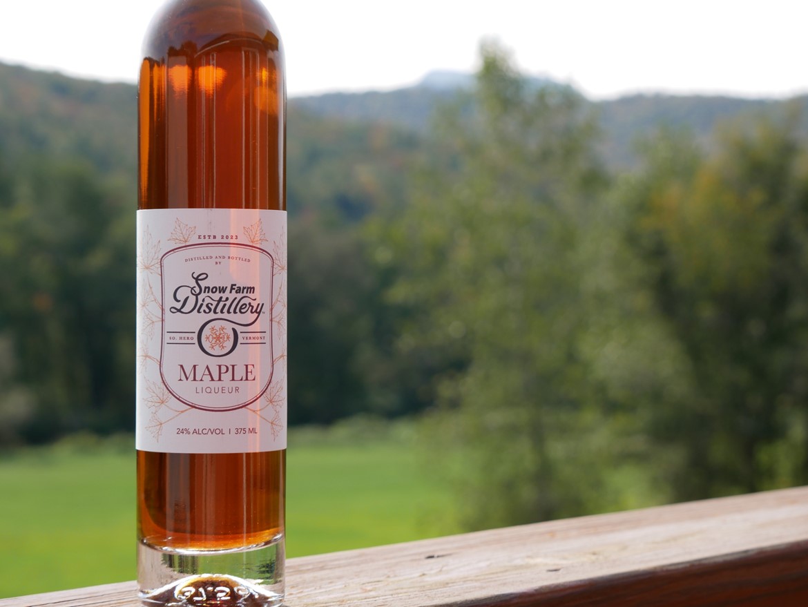 maple liqueur bottle on ledge mountains